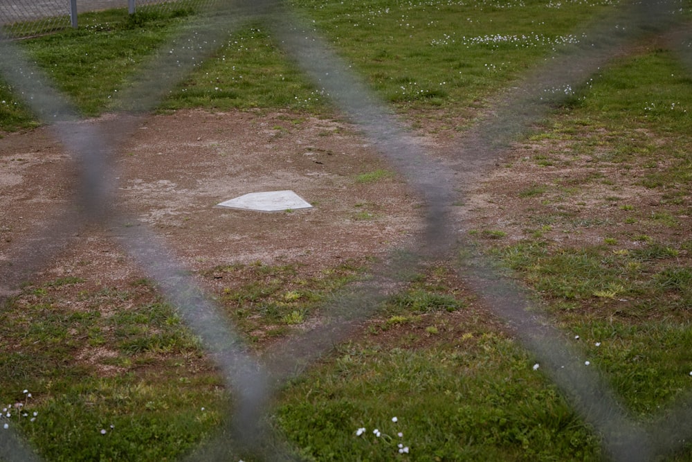a baseball field behind a chain link fence
