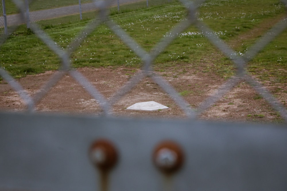 a view of a baseball field through a fence