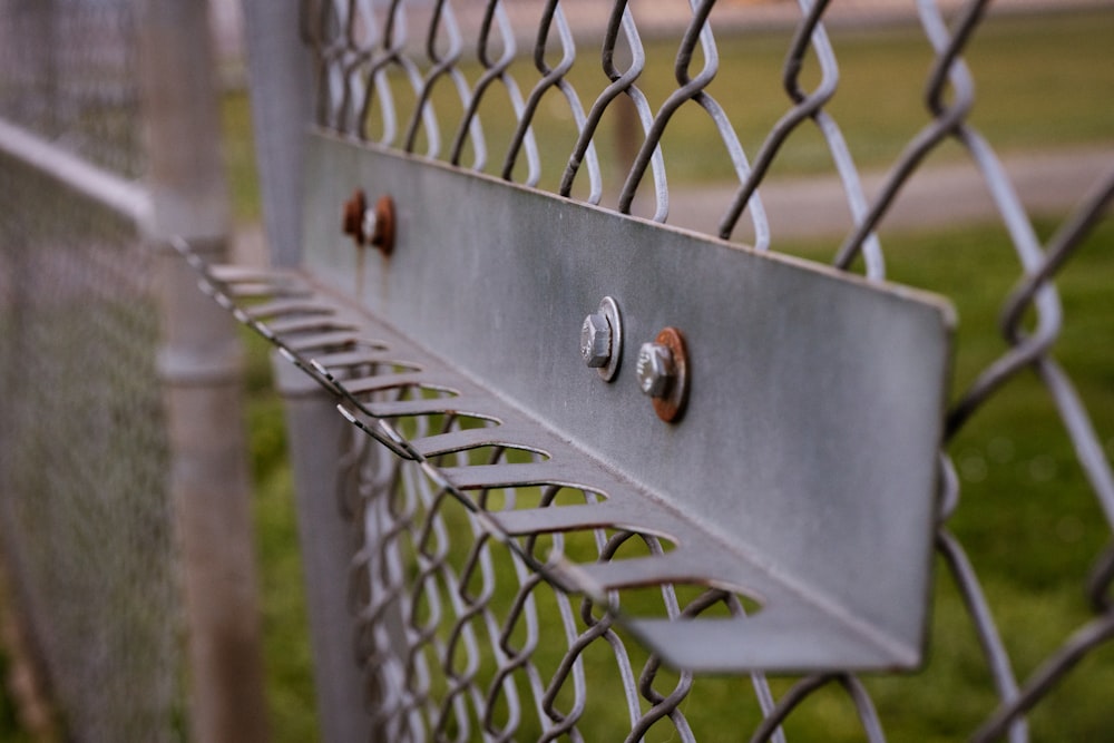a metal fence with three knobs on it