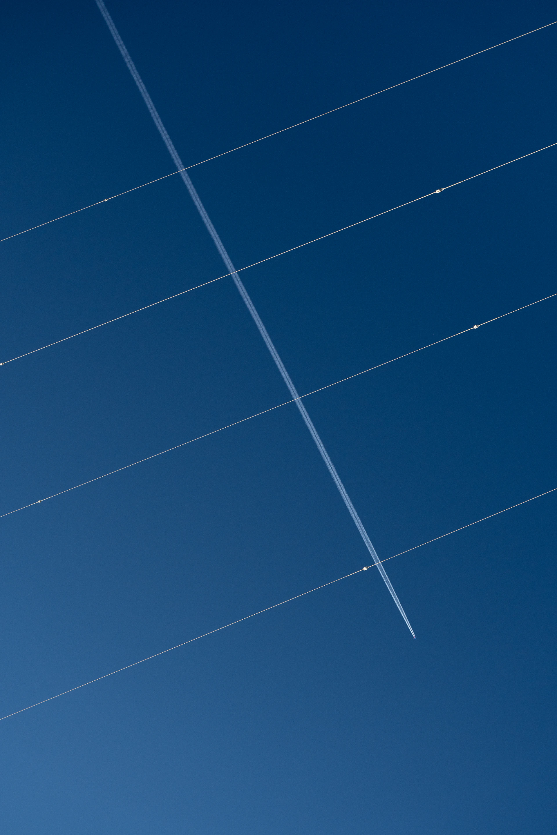 a plane is flying in the blue sky