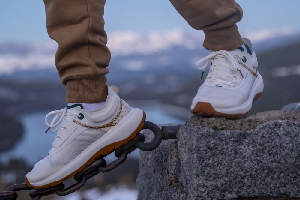 a person riding a skateboard on top of a rock