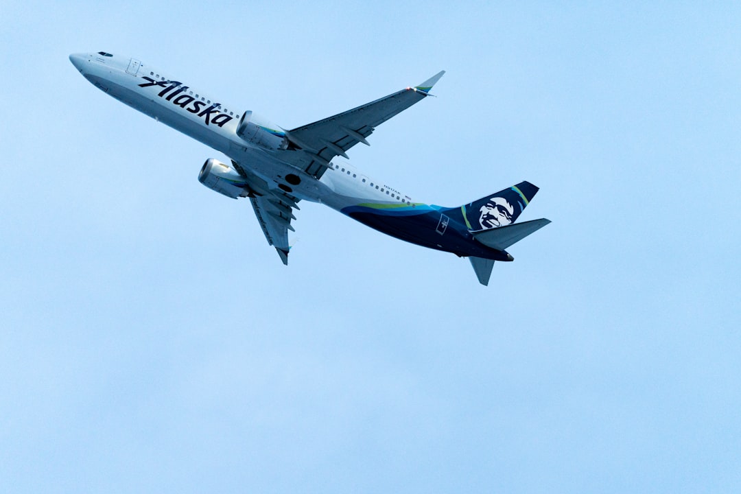 a large passenger jet flying through a blue sky,
