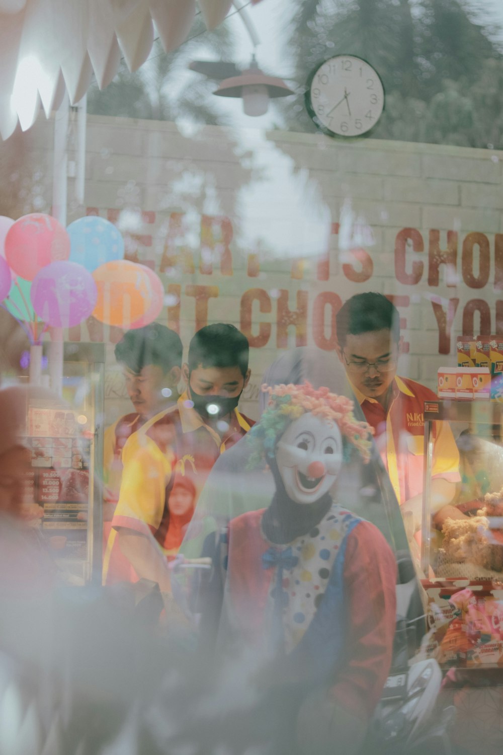a group of clowns standing in front of a store window