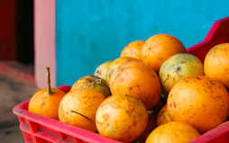 a red crate filled with lots of oranges