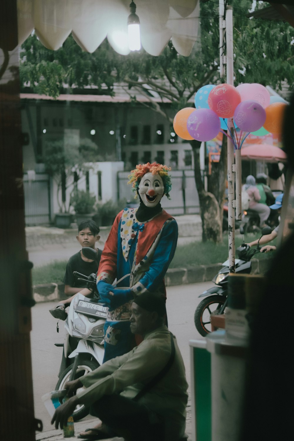 a clown is riding a motorcycle on the street