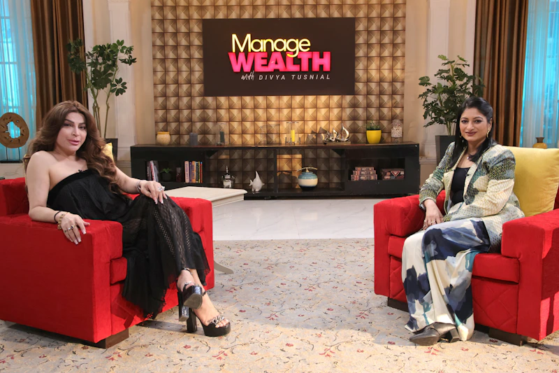 a couple of women sitting on top of red chairs
