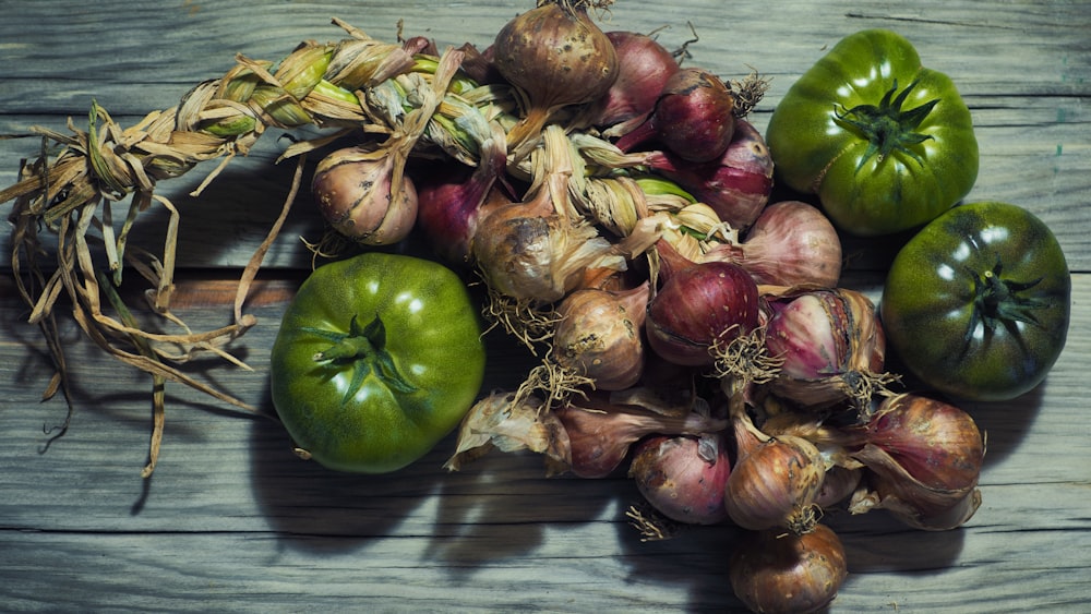 a pile of vegetables sitting on top of a wooden table