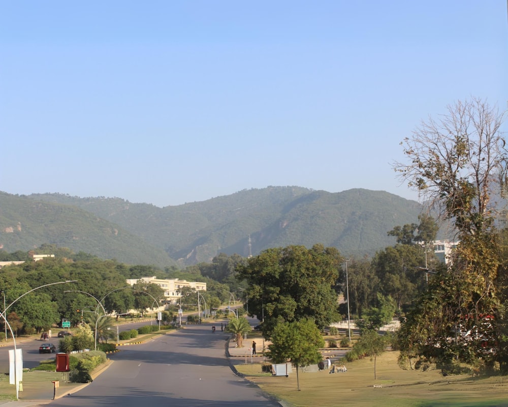 a view of a street with mountains in the background