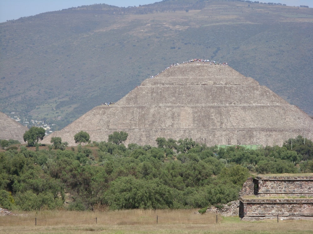 a large pyramid in the middle of a field