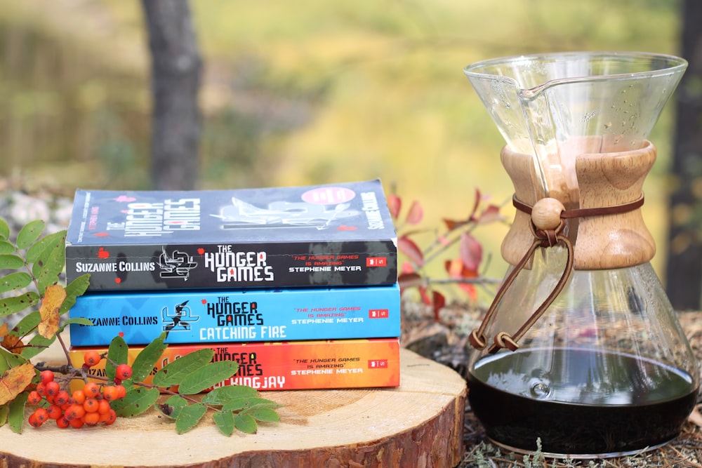 a stack of books sitting on top of a tree stump