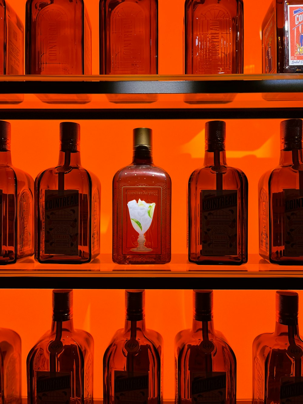 a shelf filled with lots of bottles of liquor