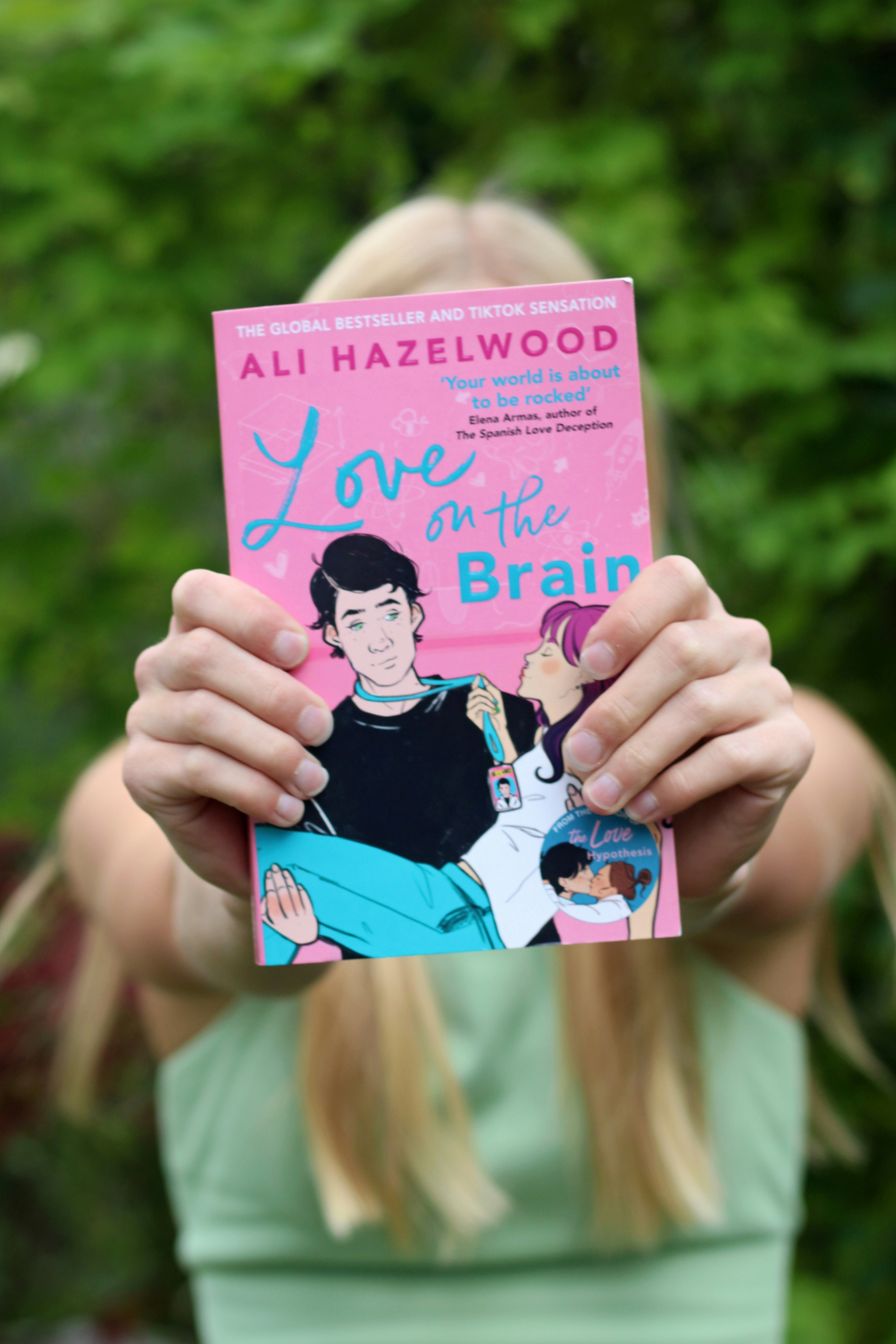 a girl holding up a book in front of her face