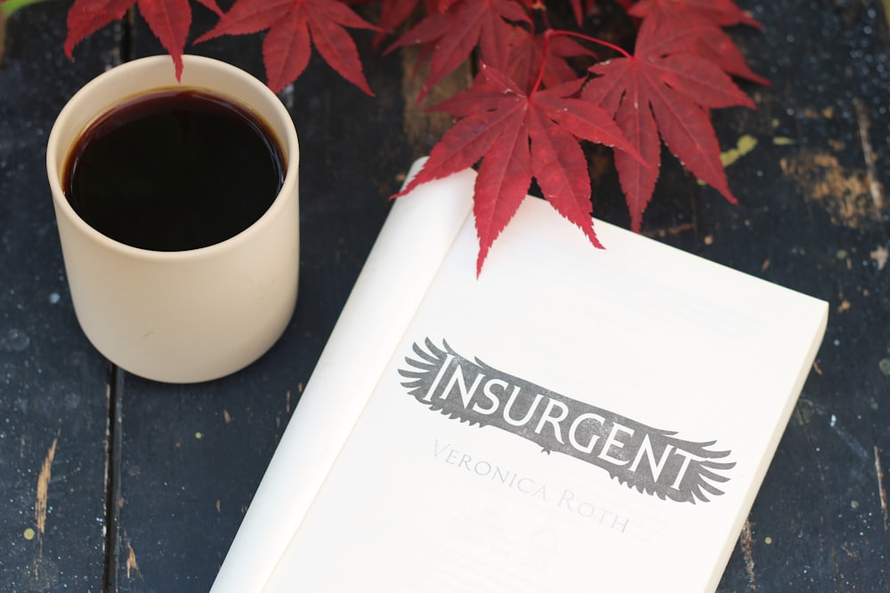 a cup of coffee and a book on a table