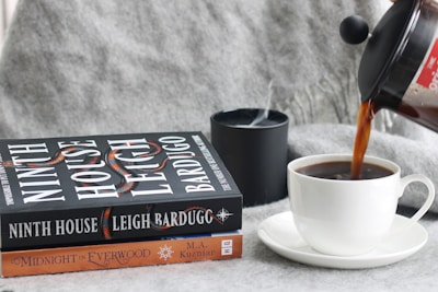 a cup of coffee is being poured into a mug