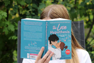 a girl reading a book about the love of hypothhes