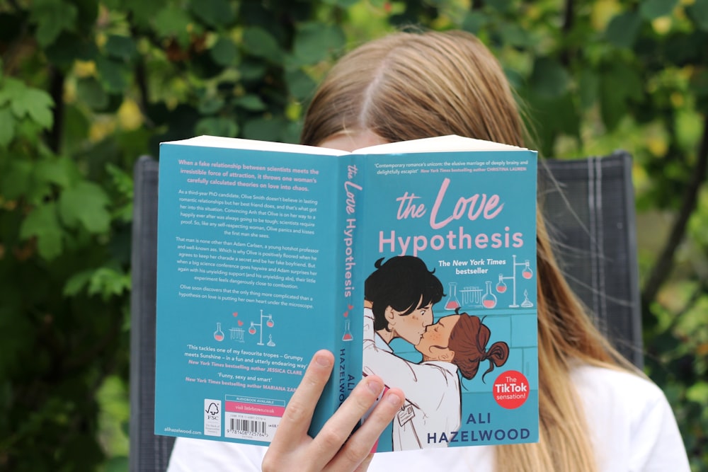 a girl reading a book about the love of hypothhes