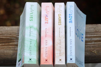 a row of books sitting on top of a wooden table
