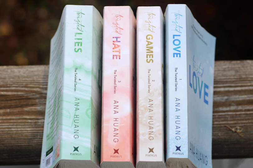 a row of books sitting on top of a wooden table