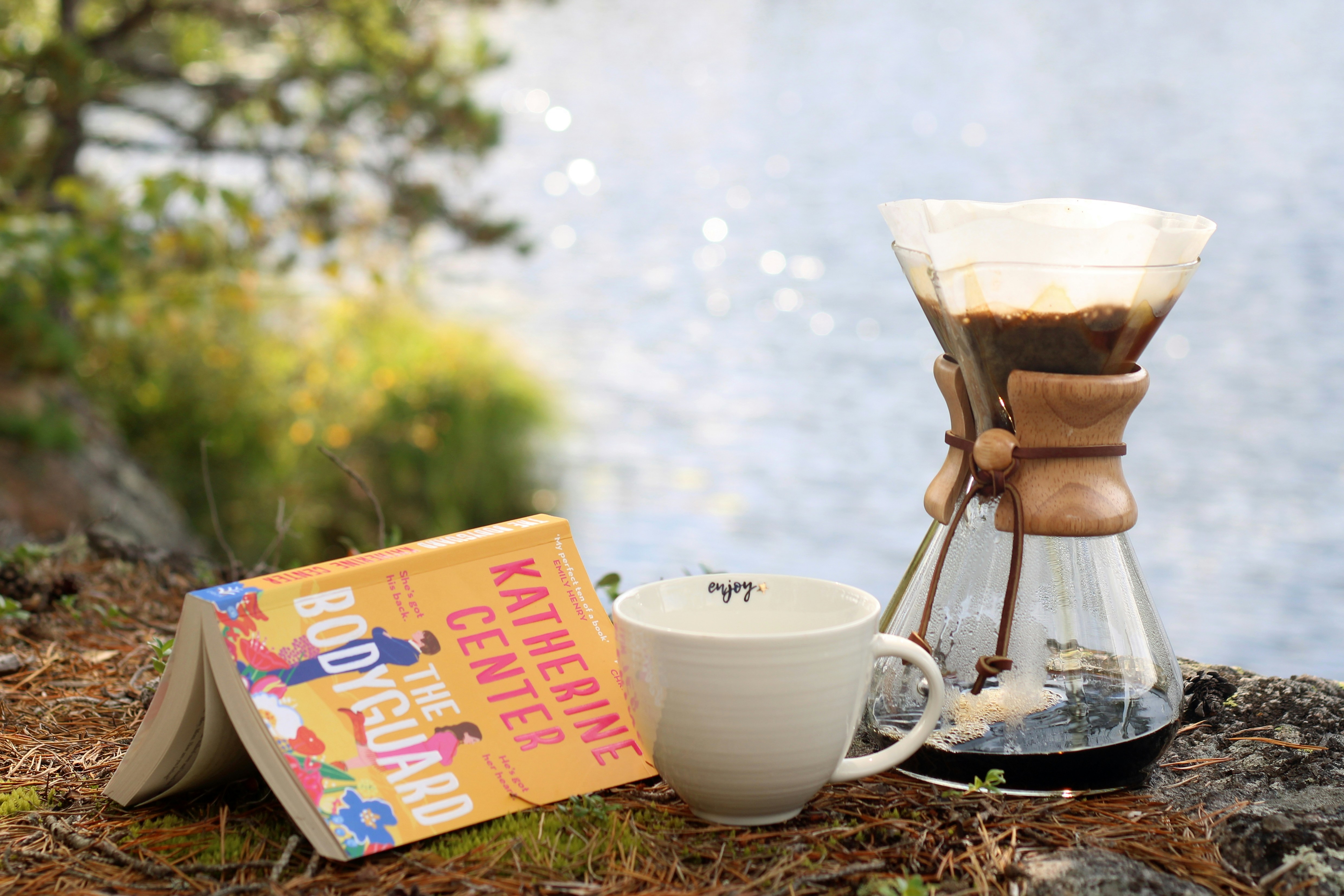 a cup of coffee sitting next to a book
