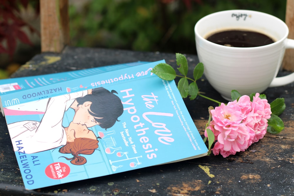 a cup of coffee and a book on a table