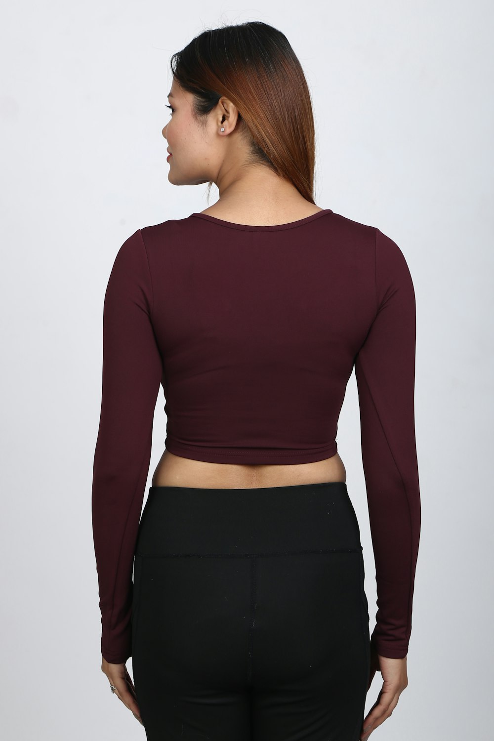 a woman in black pants and a maroon top