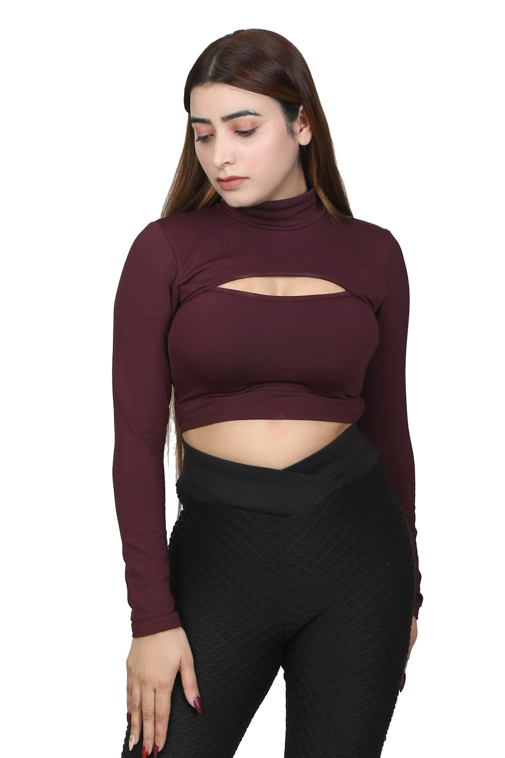 a woman wearing a maroon top and black pants