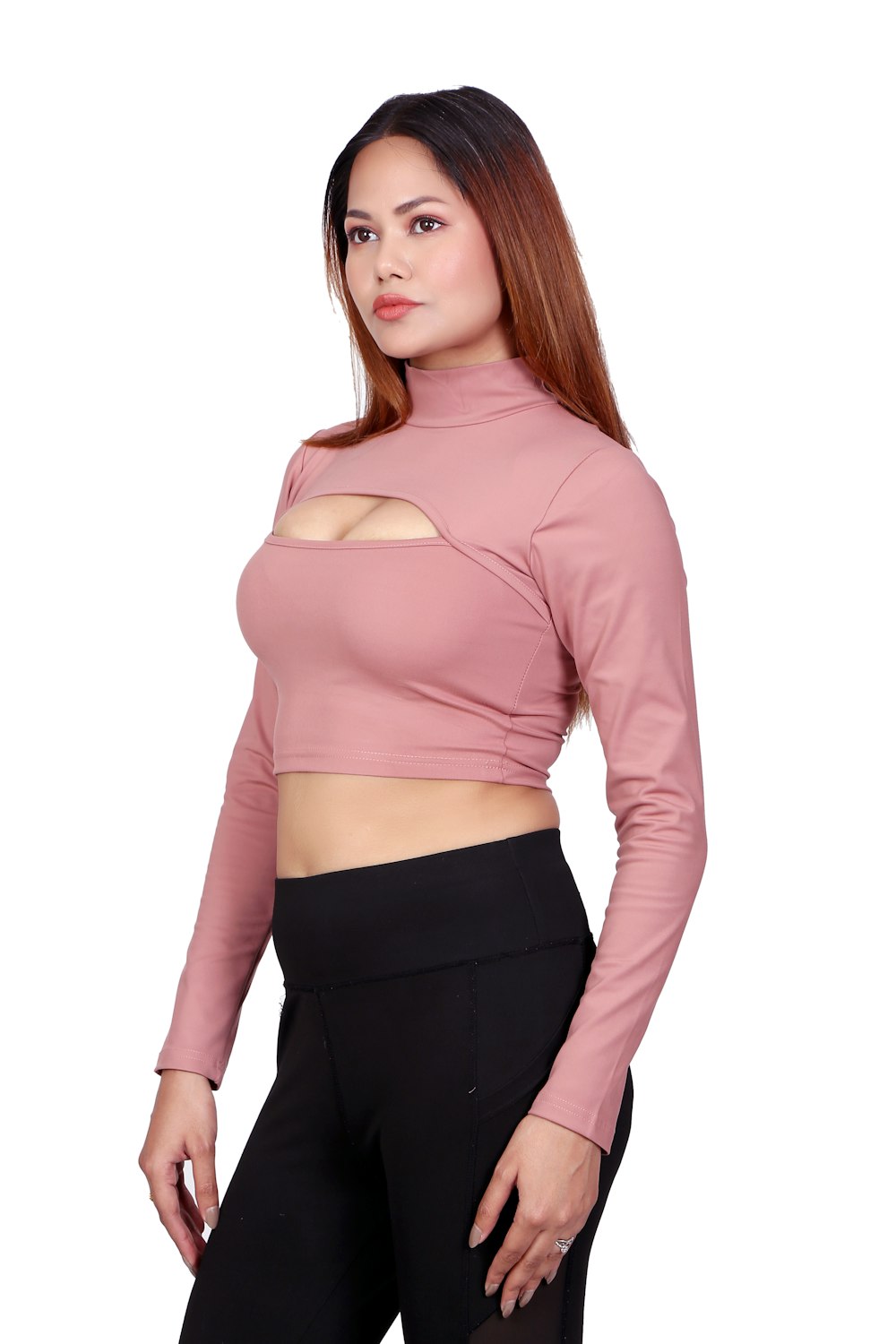 a woman wearing a pink top and black pants