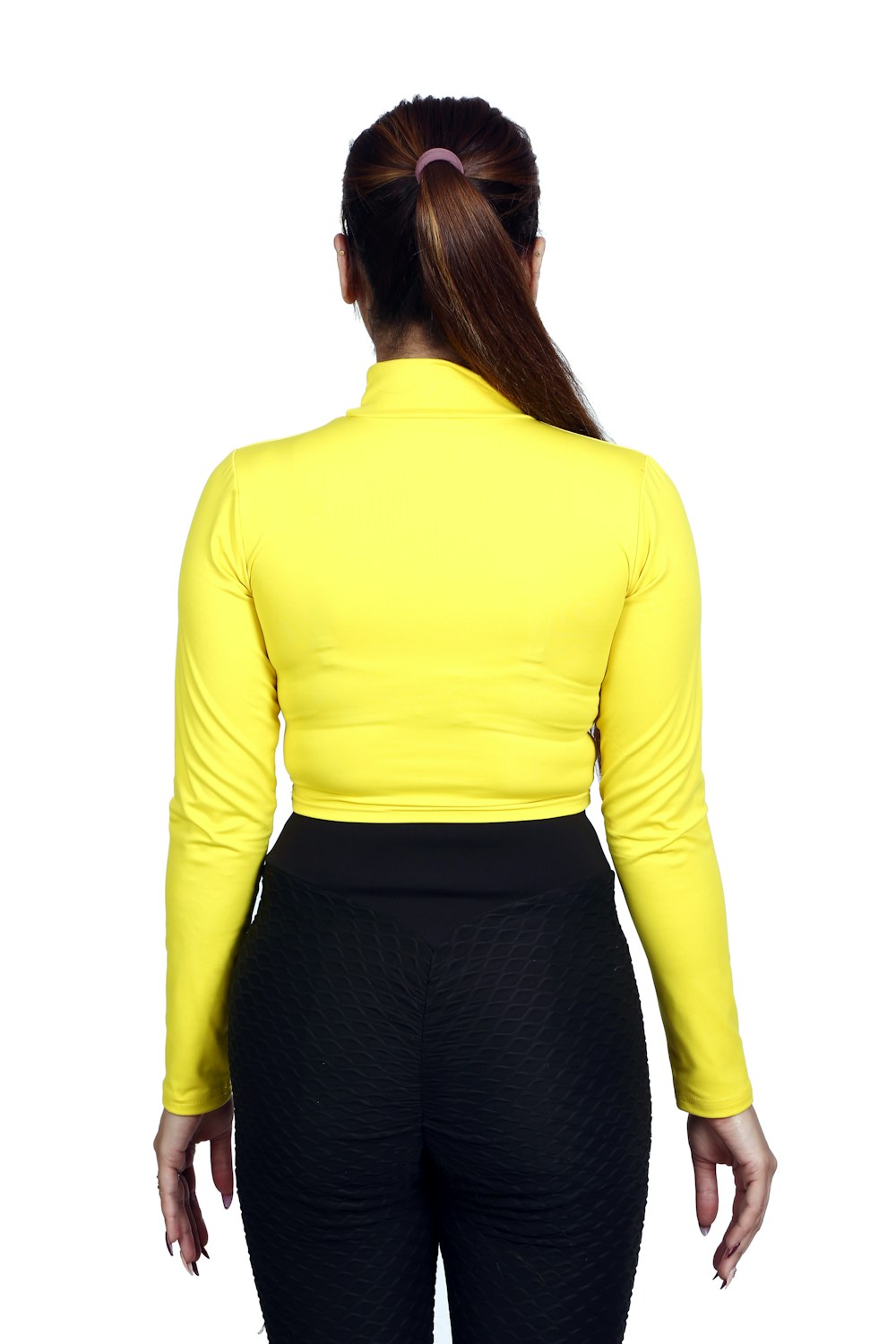 a woman wearing a yellow top and black pants