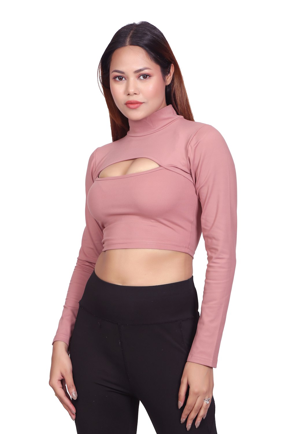 a woman wearing a pink top and black pants