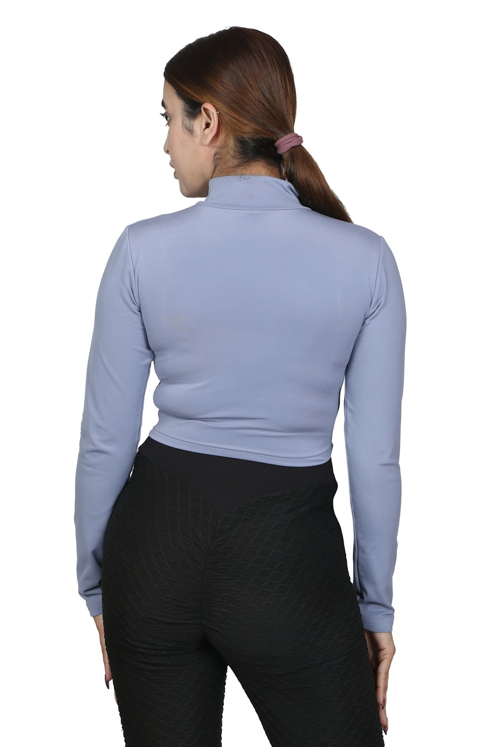 a woman wearing a blue top and black pants