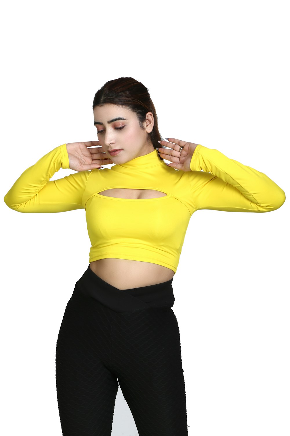 a woman in a yellow top and black pants