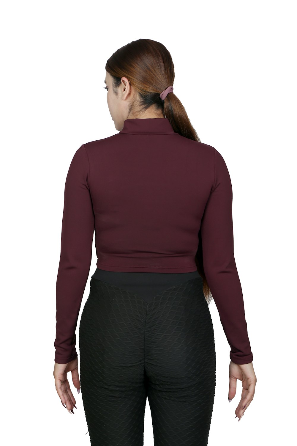 a woman wearing a maroon top and black pants