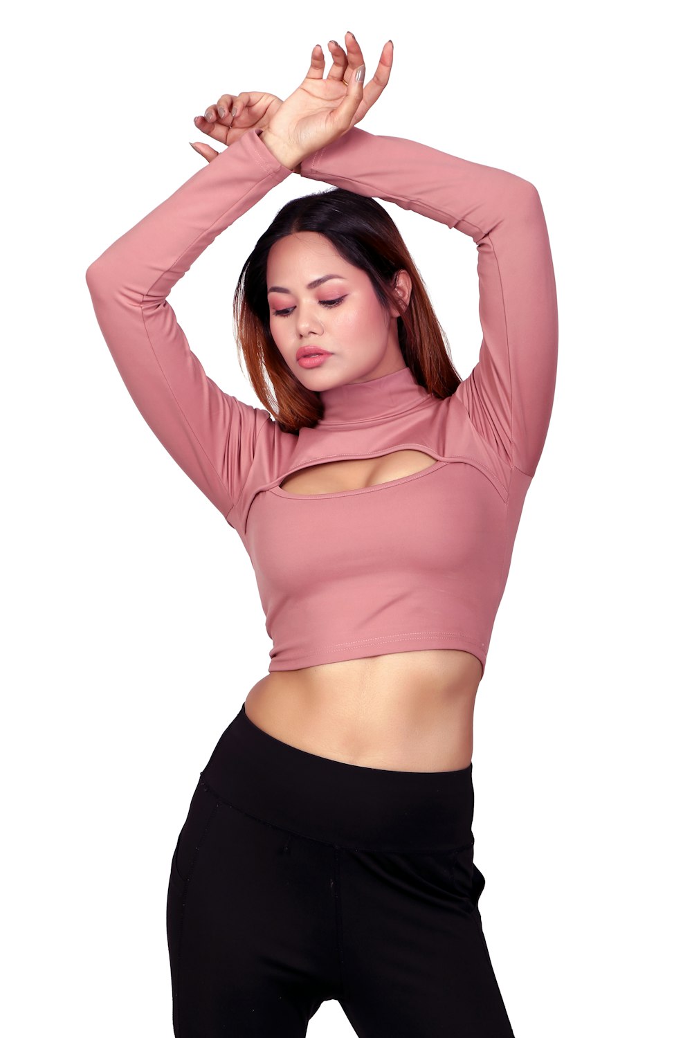 a woman in a pink top and black pants