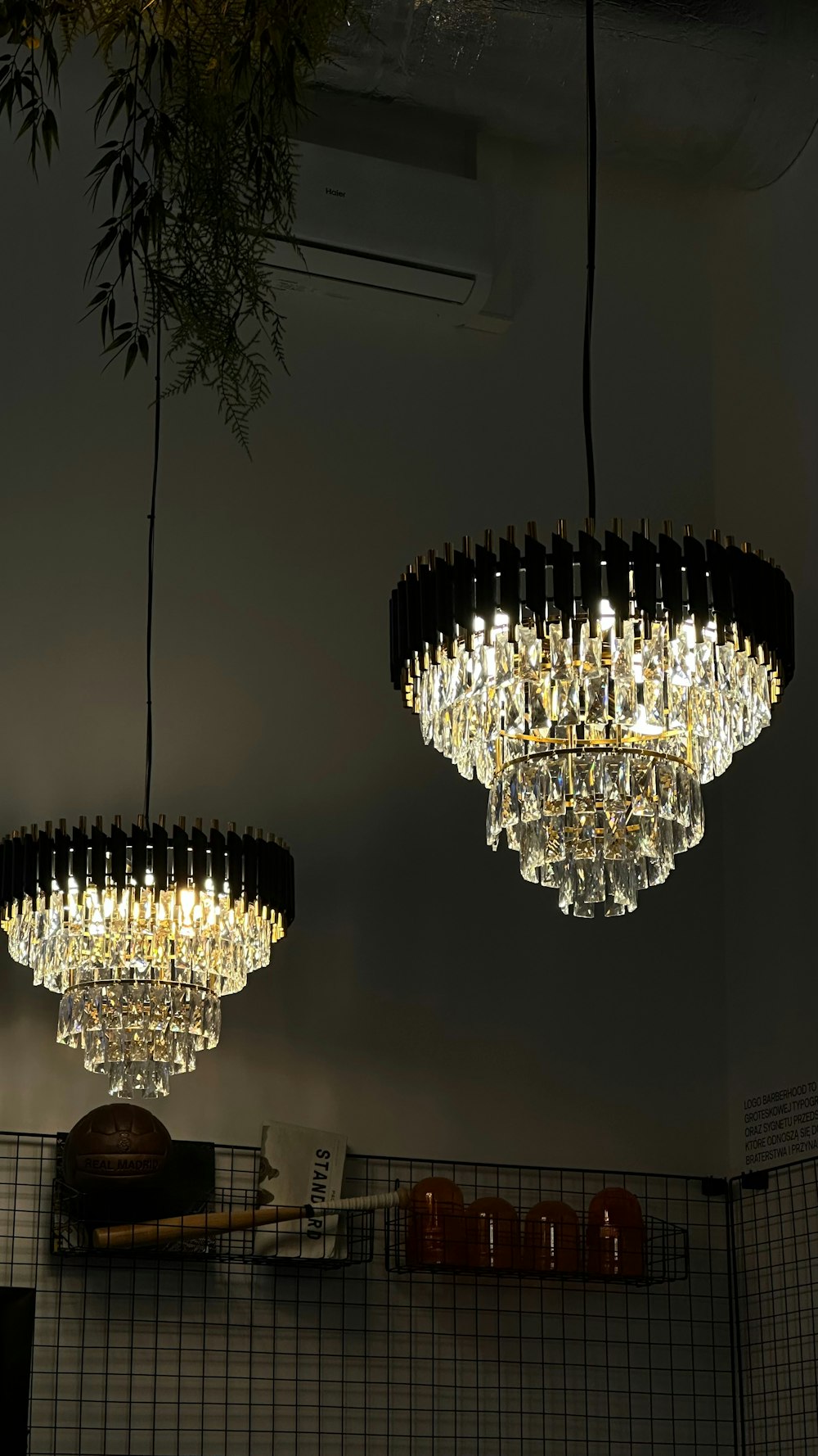 a couple of chandeliers hanging from a ceiling