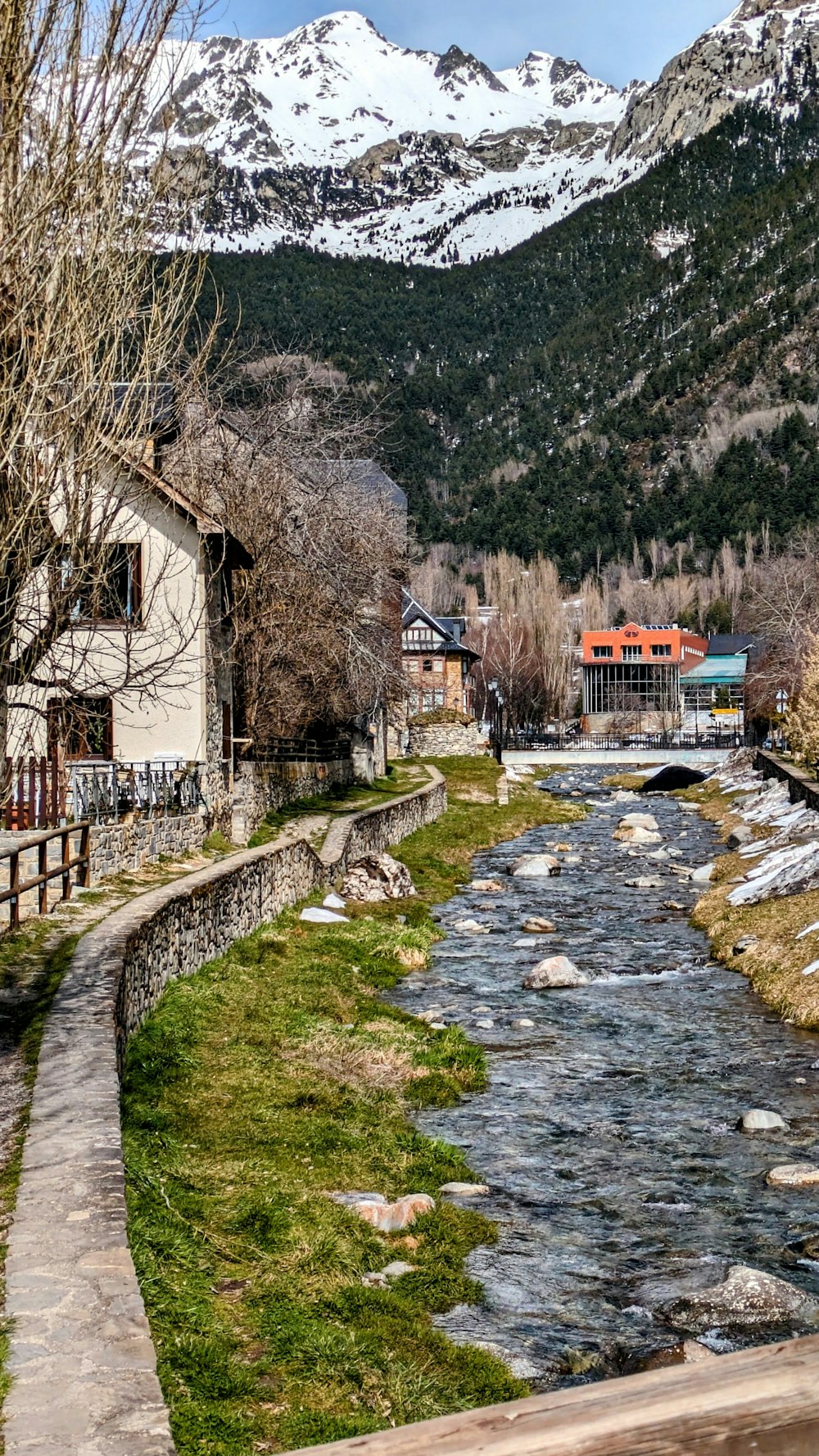 a river running through a lush green hillside