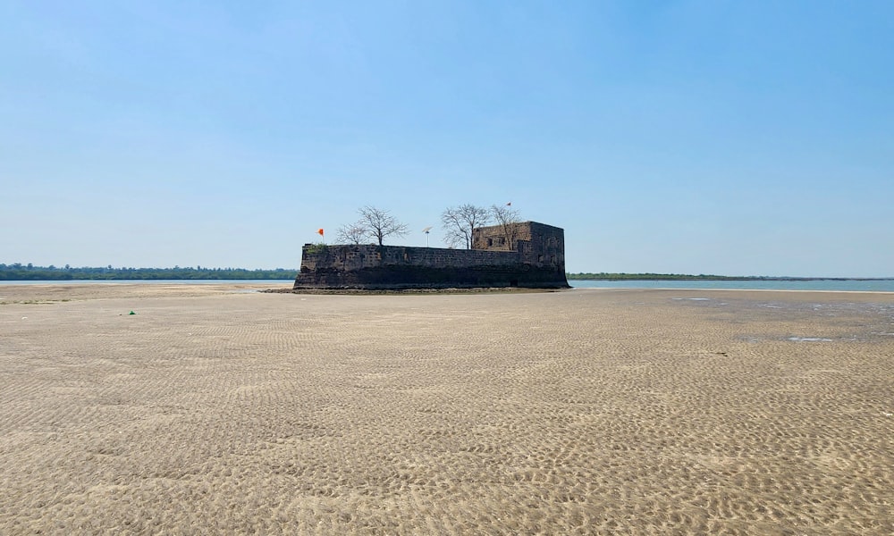 a large castle sitting on top of a sandy beach