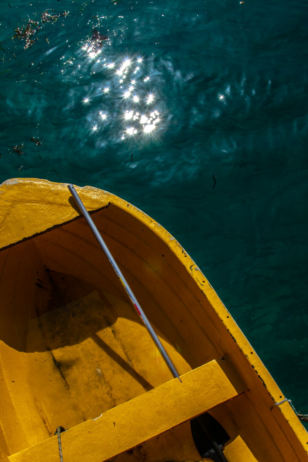 a yellow boat floating on top of a body of water