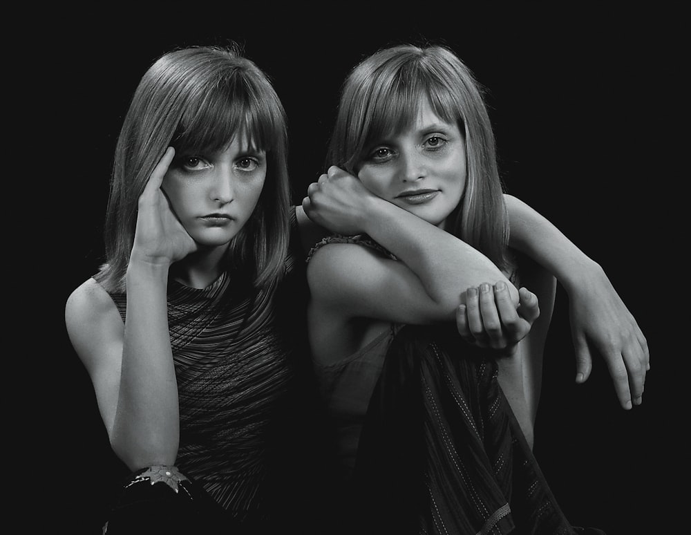 two women are posing for a black and white photo