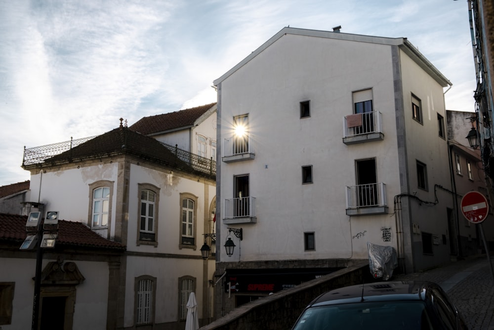 a car parked in front of a white building