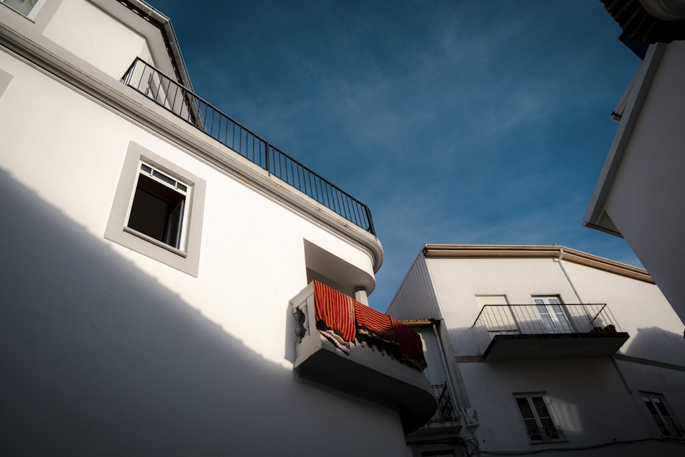 a white building with a balcony and balconies