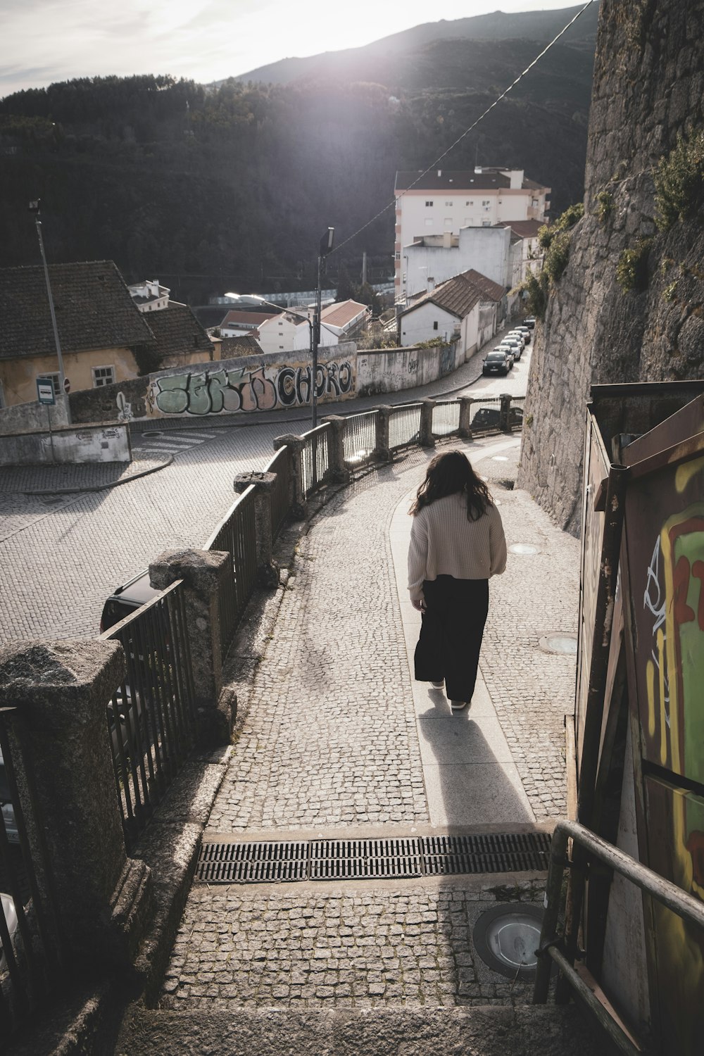 a woman walking up a set of stairs