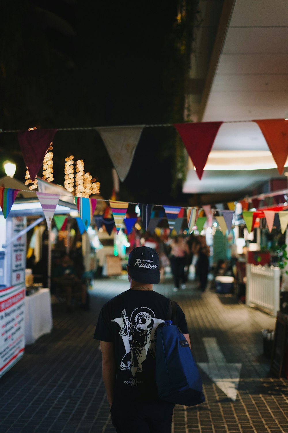 a man with a back pack walking down a street