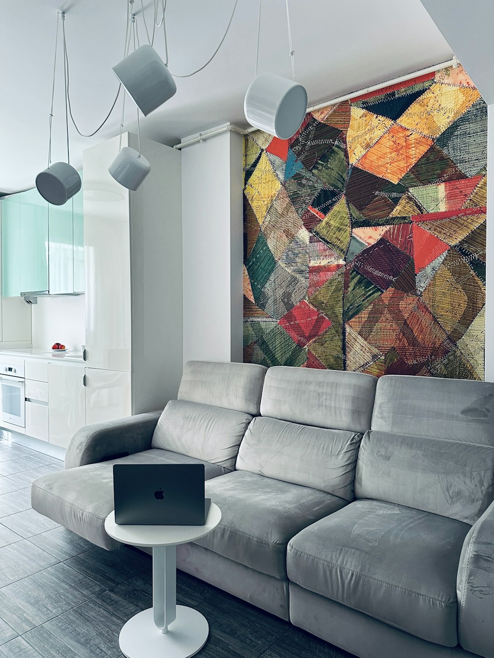 a modern living room with a large painting on the wall