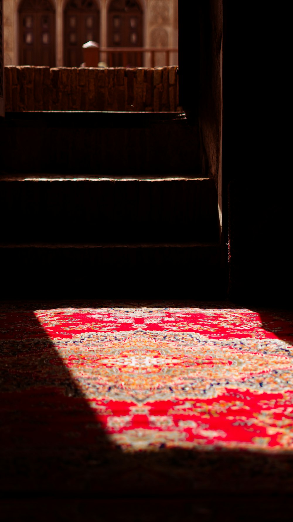 a red rug sitting on top of a wooden floor