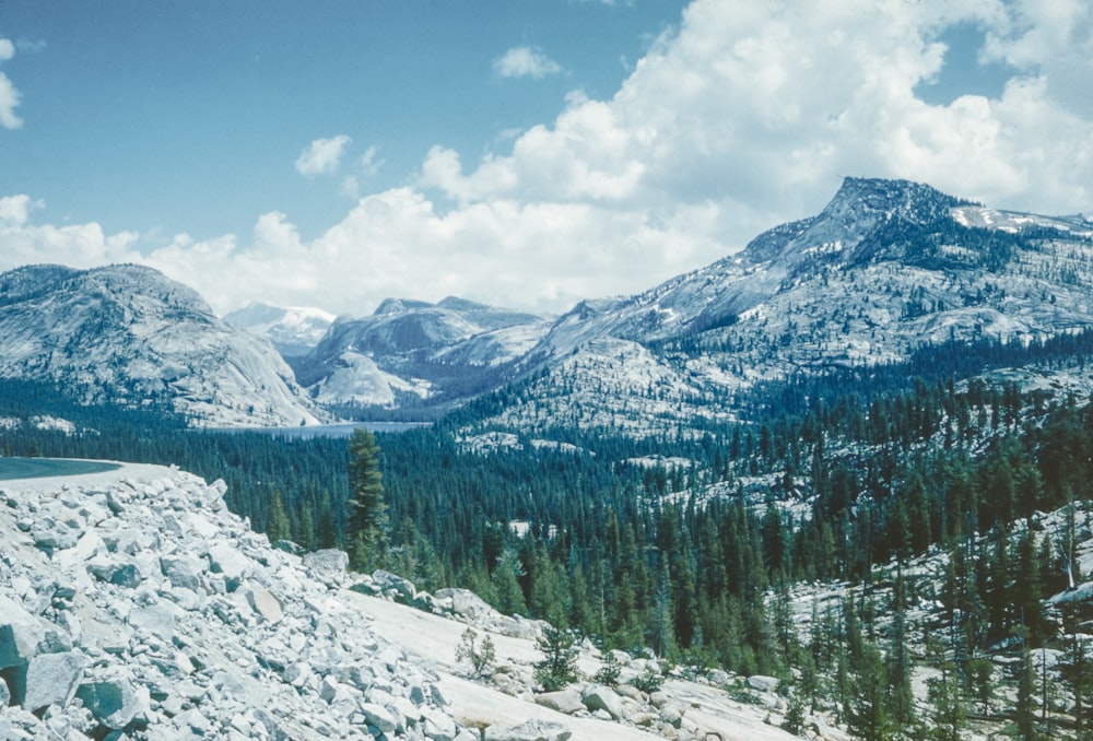 a scenic view of a mountain range with snow on the ground