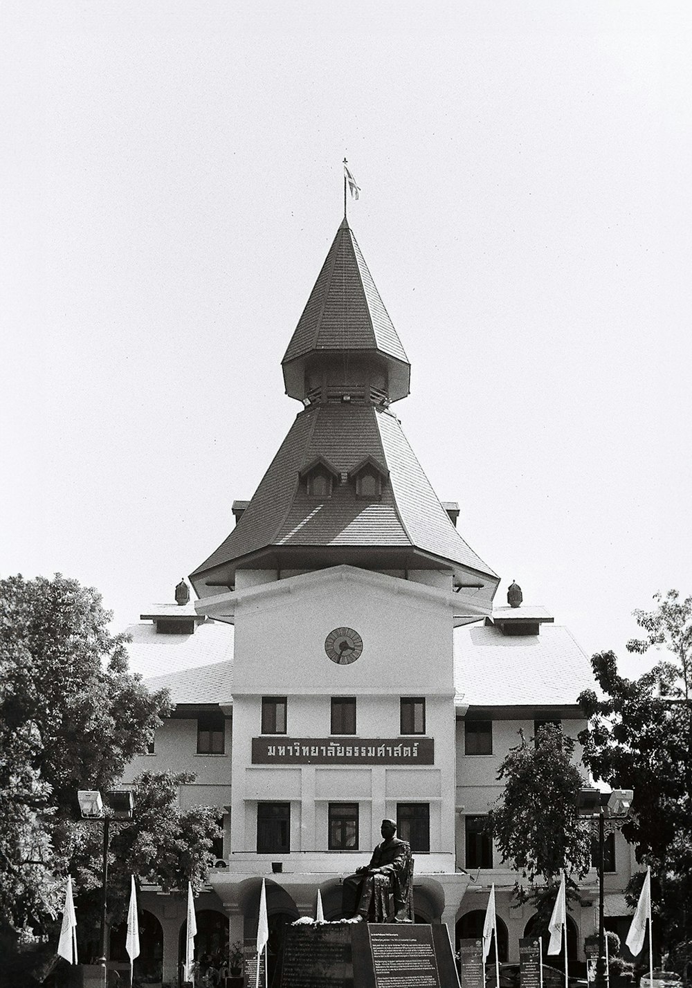 a black and white photo of a horse and carriage in front of a building