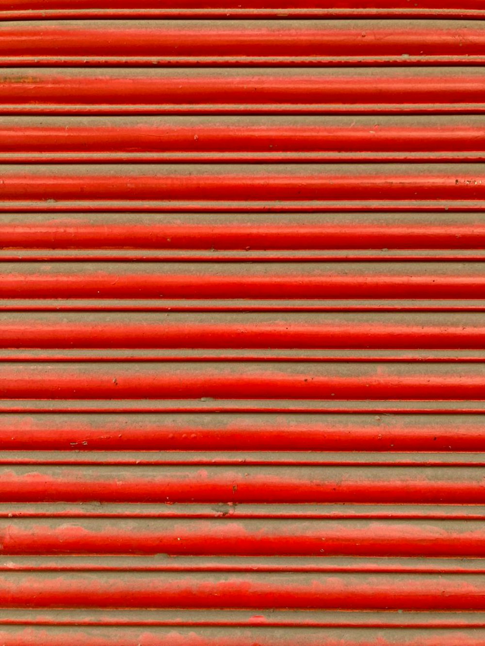 a close up of a red metal surface