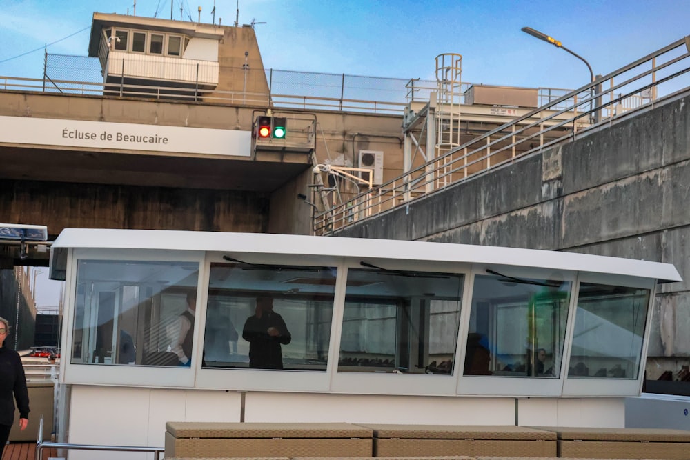 a man standing next to a boat near a bridge