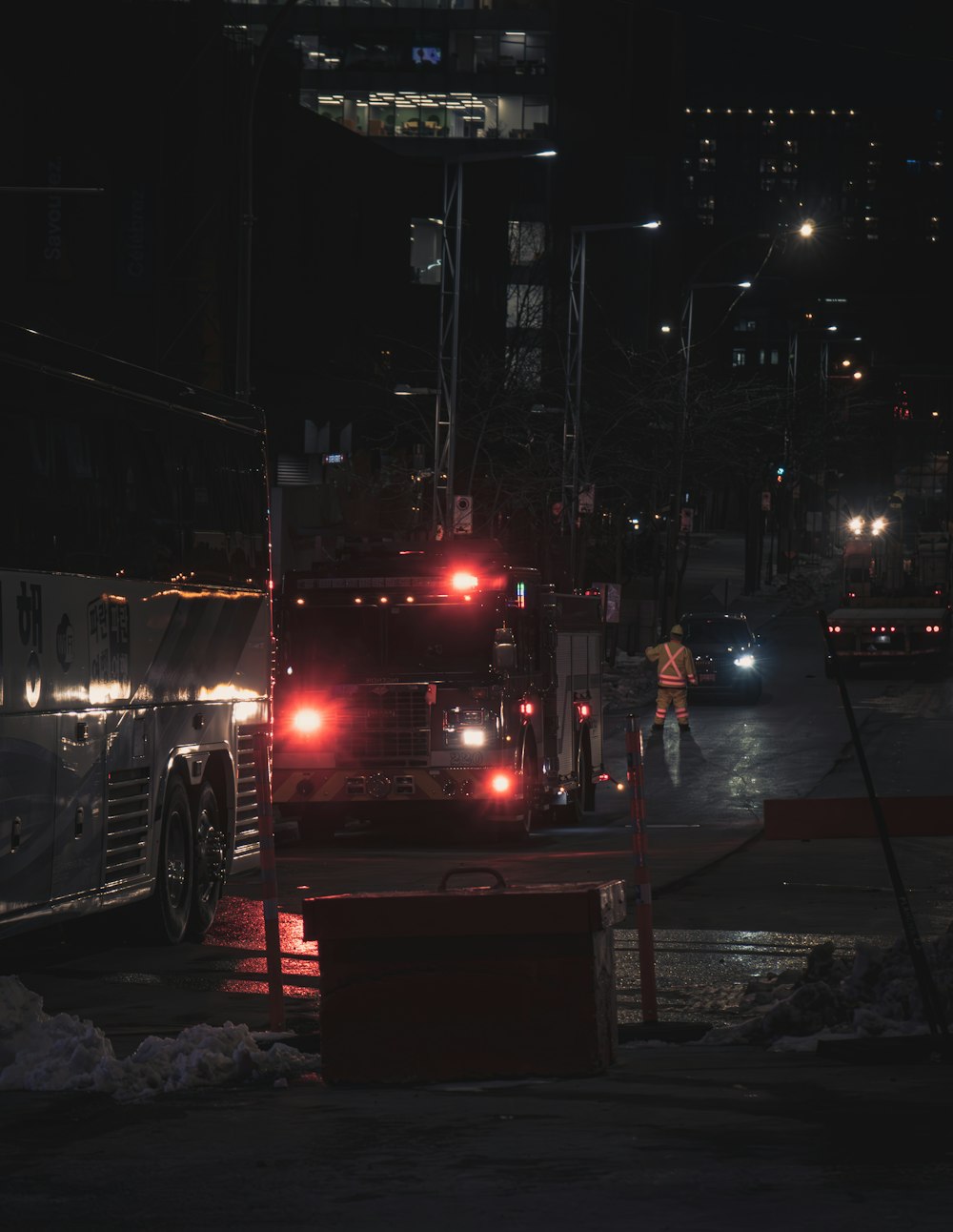 a night scene of a city street with a large truck