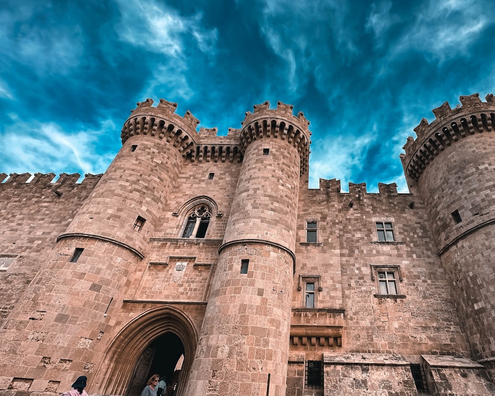 a castle with two people standing in front of it